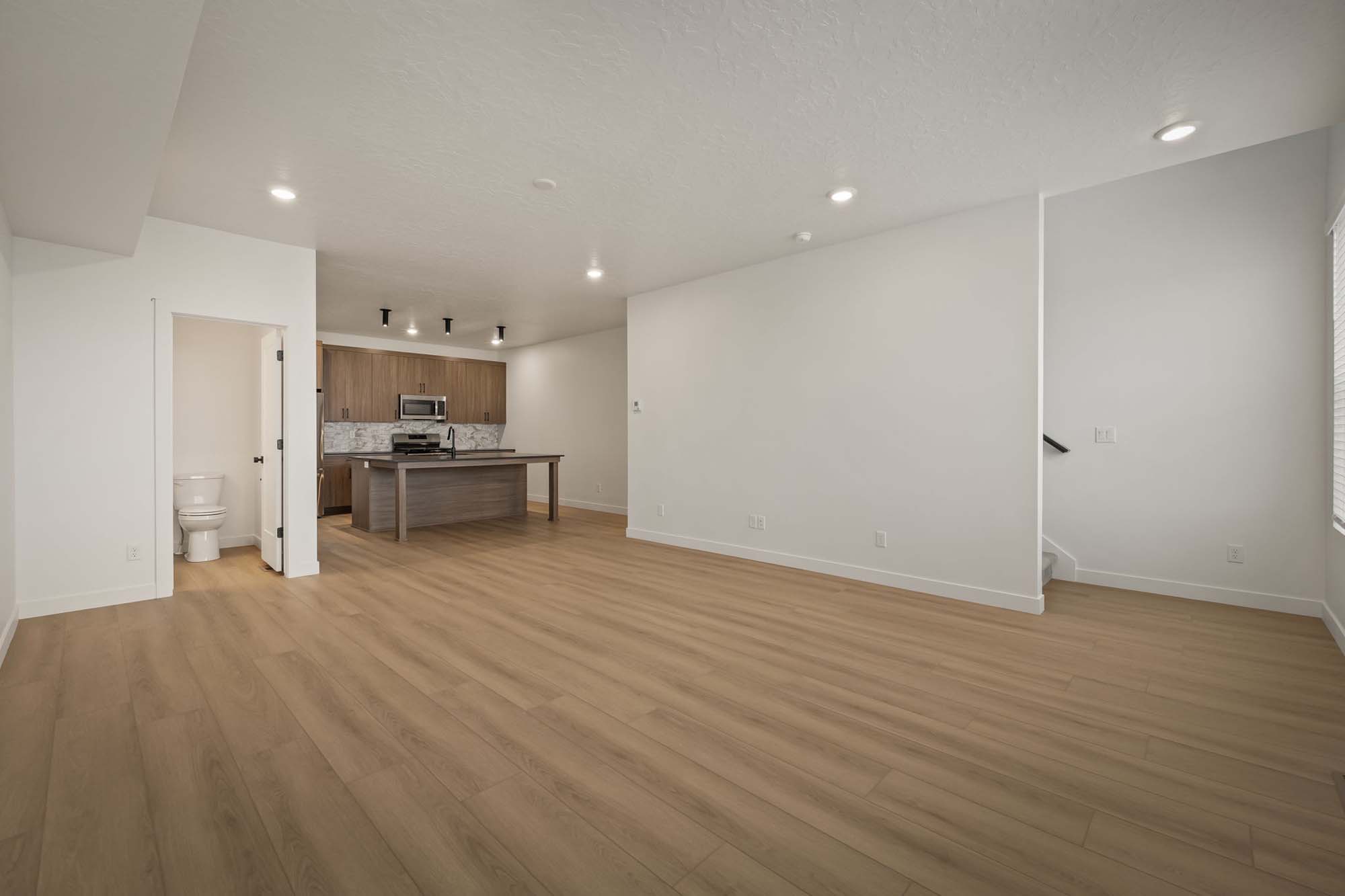 Great Room to Kitchen | Cambria E Interior Units at theHAZEL in Roy, UT by Cole West