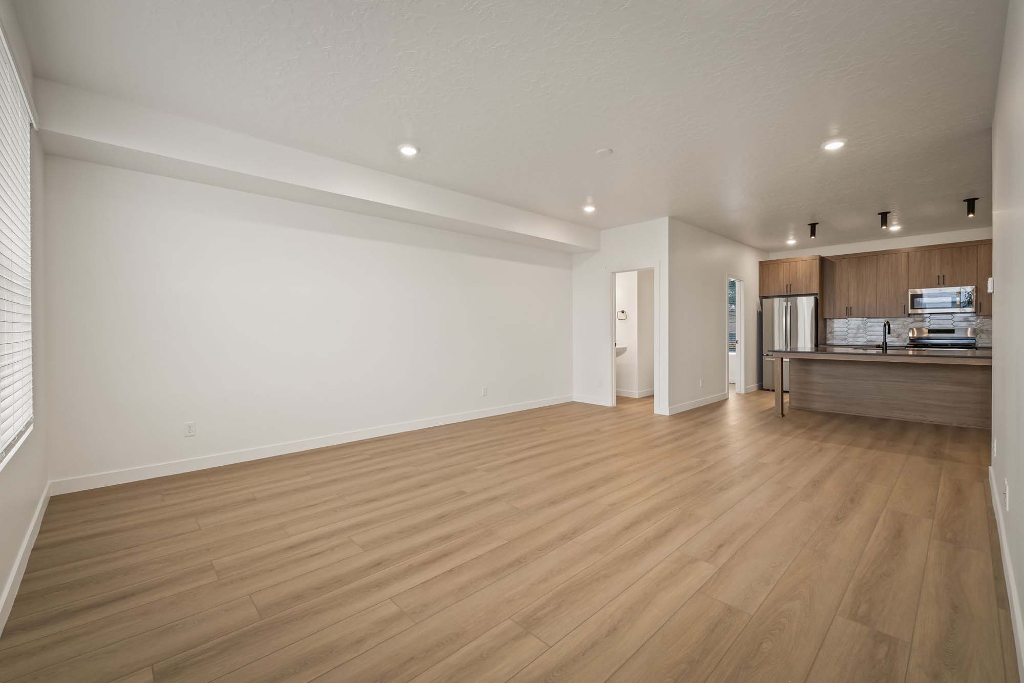 Great Room to Kitchen | Cambria E Interior Units at theHAZEL in Roy, UT by Cole West