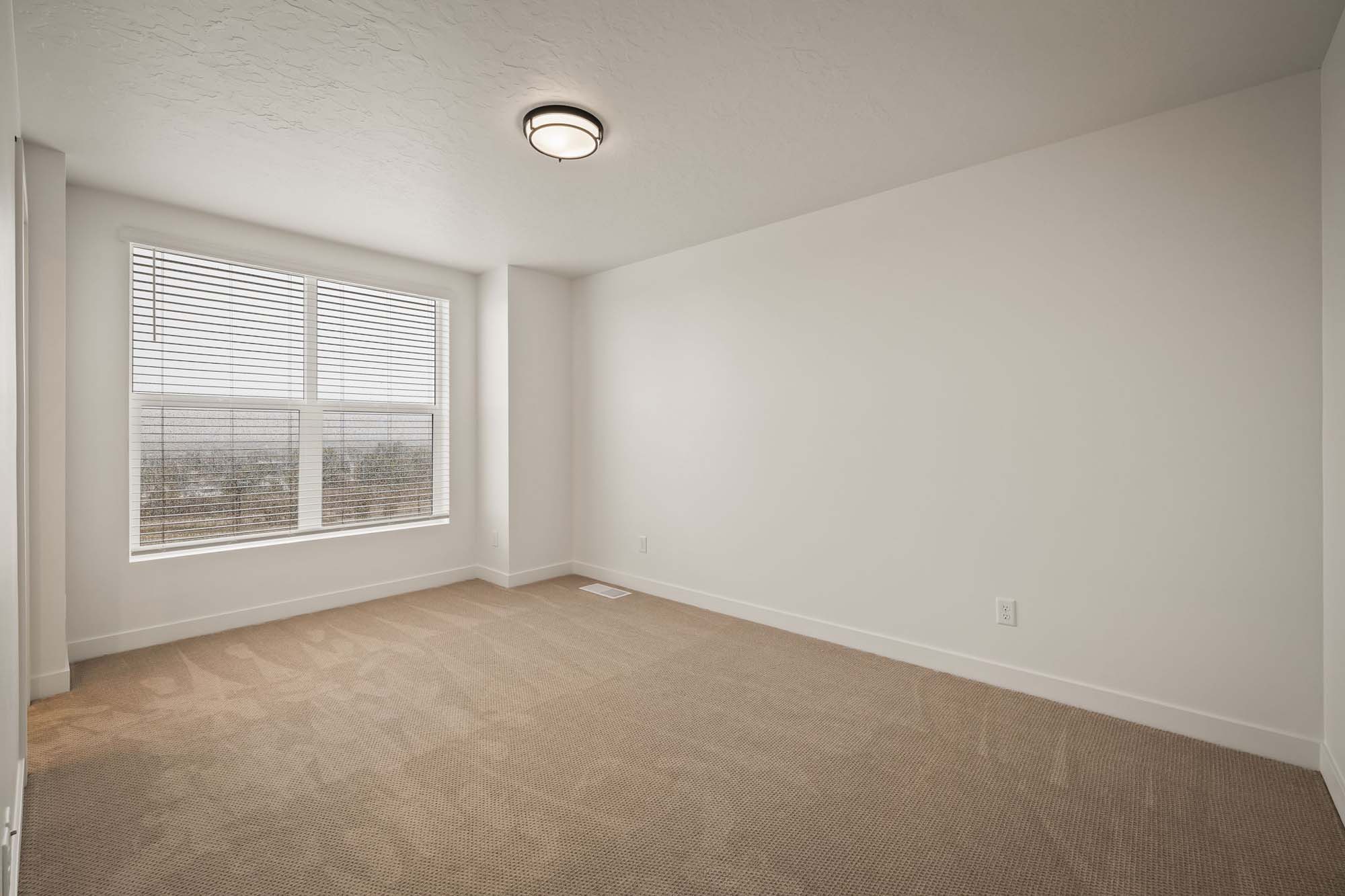 Primary Bedroom | Cambria E Interior Units at theHAZEL in Roy, UT by Cole West