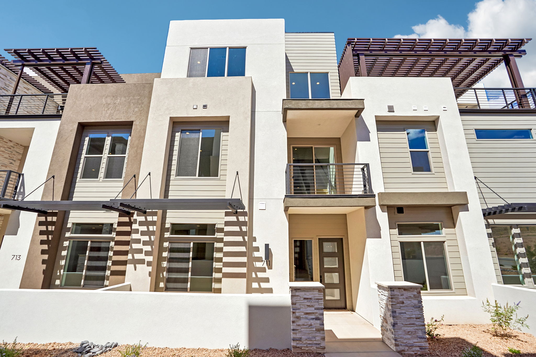 Modern three-story Pacific II vacation home at Desert Color in St. George, Utah, featuring contemporary architecture, private balconies, and rooftop pergolas.