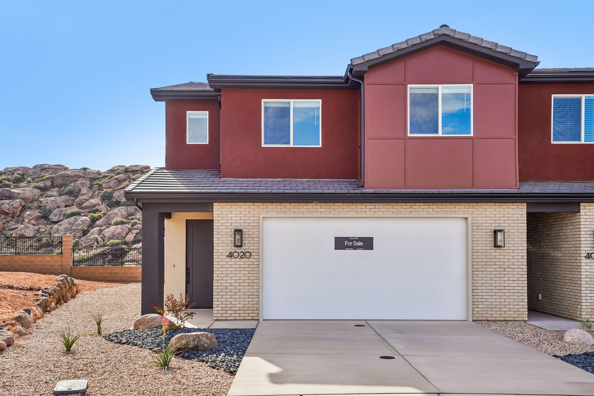 Beautiful two-story Sunrise townhome at Rise by Cole West in Washington, Utah, featuring modern architecture and a two-car garage.
