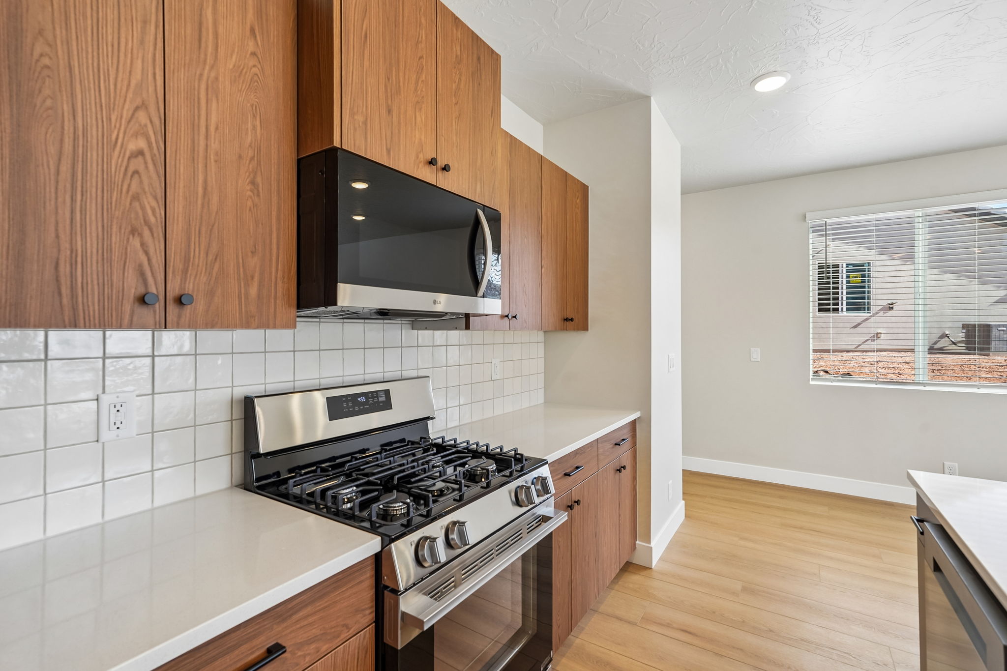 Beautiful kitchen featuring a gas range, stainless steel appliances, and warm wood cabinetry.
